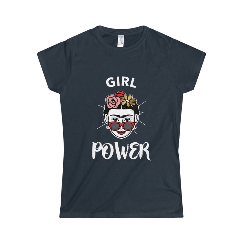May include: A dark blue t-shirt with a white graphic of a woman with flowers in her hair and sunglasses. The text "GIRL POWER" is printed below the image.