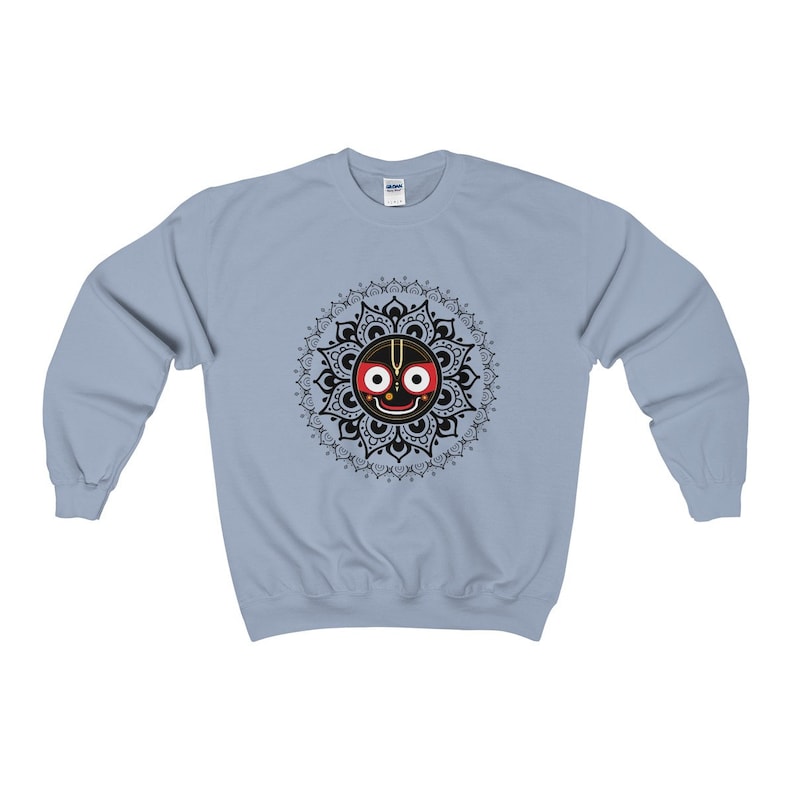 May include: A light blue sweatshirt with a black and white mandala design featuring a black face with red eyes and a third eye in the centre.