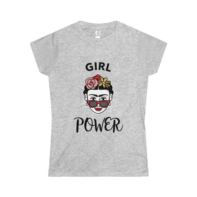 May include: Gray t-shirt with a black and white illustration of a woman with flowers in her hair and sunglasses. The text "GIRL POWER" is printed below the illustration.