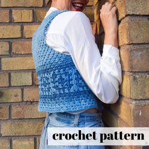May include: A blue crochet vest with a square stitch pattern. The vest is cropped and worn over a white shirt and blue jeans. The text "crochet pattern" is visible at the bottom of the image.