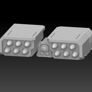 May include: Two gray, rectangular missile launchers with rounded missile heads. Each launcher has a series of eight missile heads. The launchers are connected by a central component with a circular detail.
