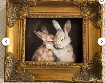 an 8x10” canvas geclee of hugging bunnies .place in ornate heavy gold frame