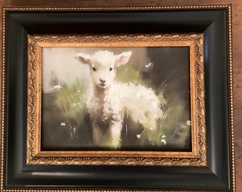 A wonderful 5x7”” canvas geclee of a sweet lamb. Placed in a black and gold trim resin frame. Ready to hang