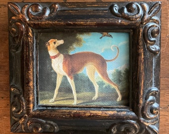 May include: A framed painting of a brown and white dog with a red collar, standing in a grassy field with trees in the background.