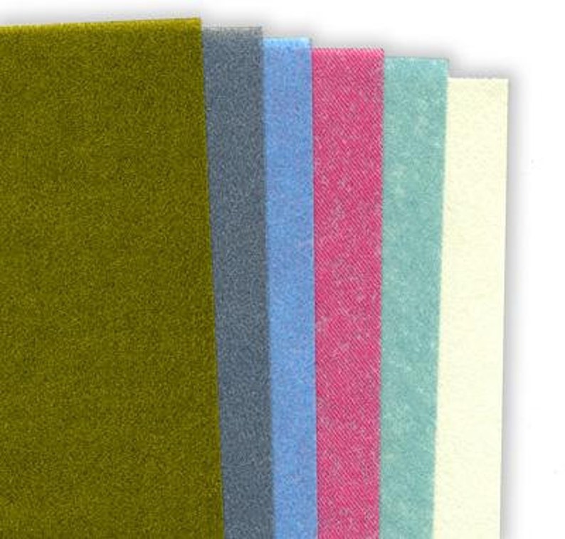 May include: Six different fabric swatches in various colors and textures. The swatches are arranged vertically from left to right. The colors are olive green, gray, light blue, pink, light blue-green, and cream.