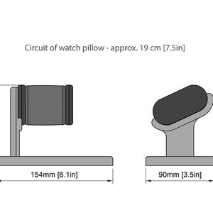 May include: A black and white line drawing of two watch pillow stands. The stands are made of a gray material and have a rectangular base. The pillow on the left stand is a cylinder shape and the pillow on the right stand is an oval shape. The dimensions of the stands are labeled in millimeters and inches. The text 'Circuit of watch pillow - approx. 19 cm [7.5in]' is at the top of the image.