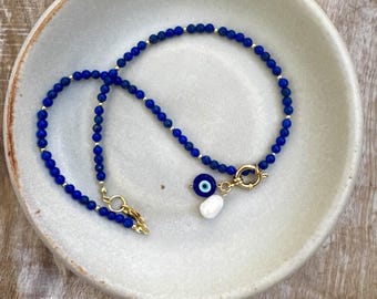 Navy blue gold beaded necklace with charms