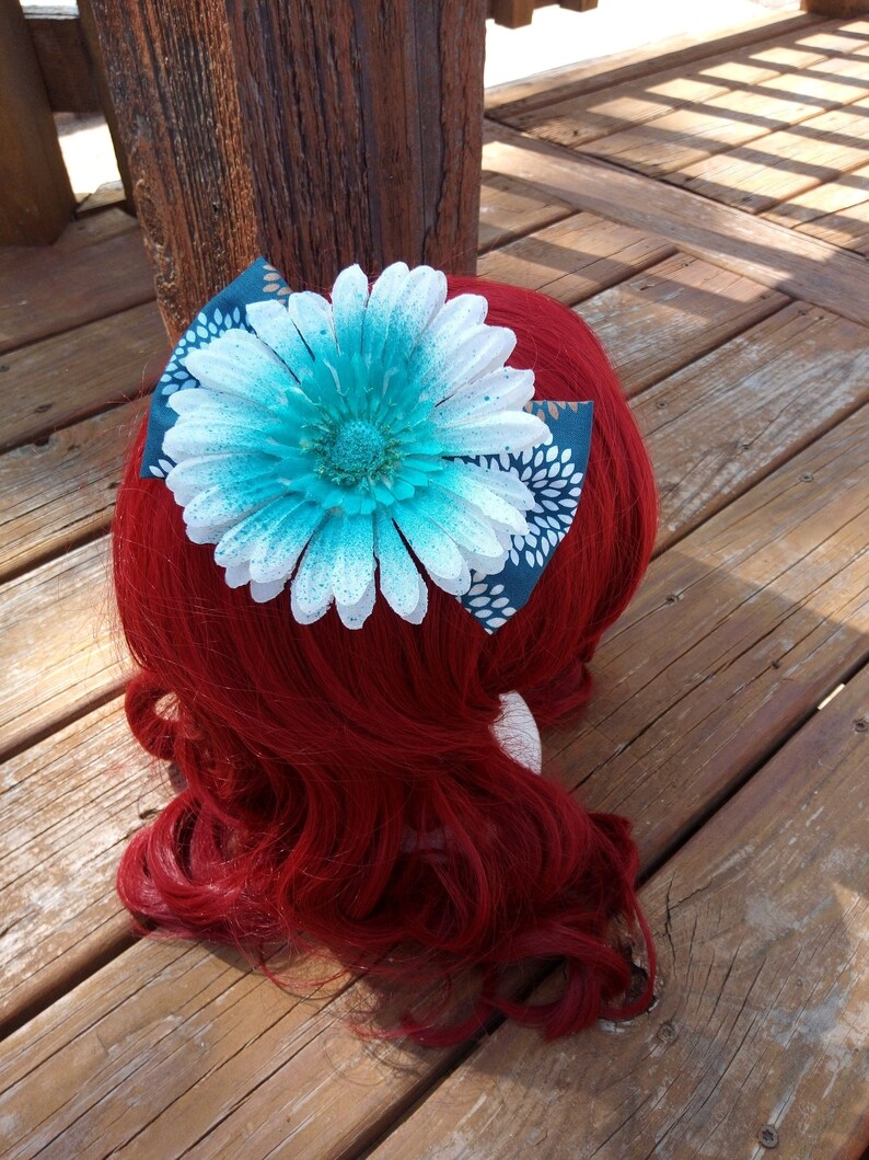 Blue Speckled White Flower On A Floral Blue Bow