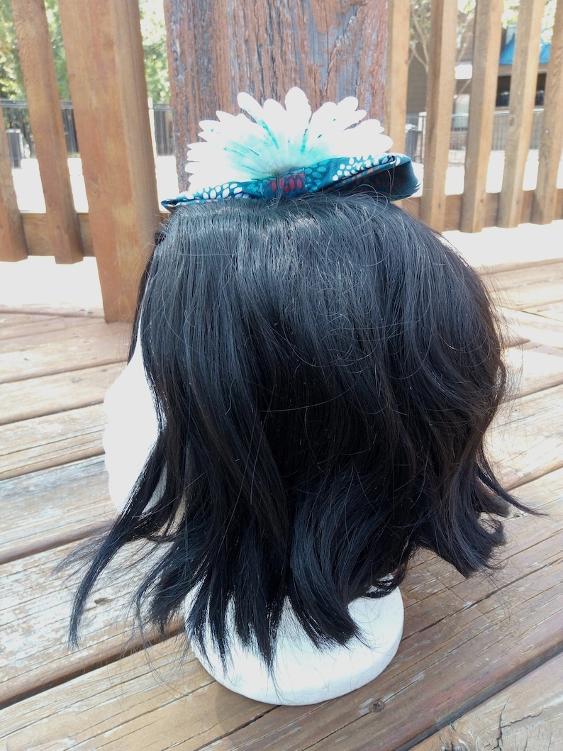 Blue Speckled White Flower On A Floral Blue Bow