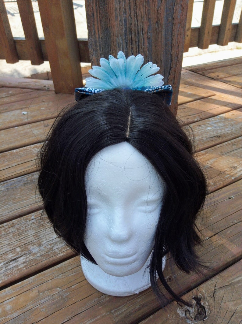 Blue Speckled White Flower On A Floral Blue Bow