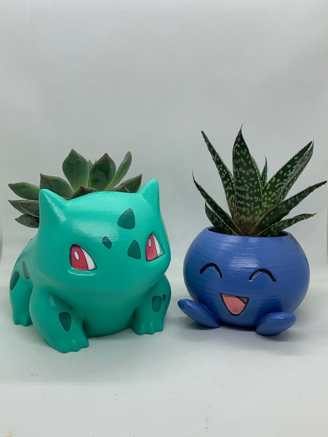 Painted Bulbasaur and Oddish Planters with Live plant.