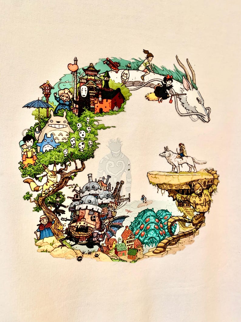 May include: A white t-shirt with a colorful graphic print of characters and scenes from Studio Ghibli films. The design includes Totoro, No Face, Howl's Moving Castle, Kiki's Delivery Service, and Spirited Away.