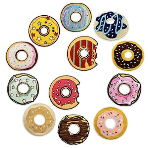 May include: A collection of twelve embroidered donut patches featuring various designs, including yellow with stars, blue with icing, chocolate with sprinkles, pink with white dots, and red with stripes, arranged in a circular pattern.