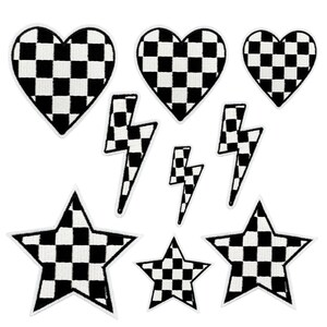 May include: A collection of eight embroidered patches featuring a black and white chequered pattern. The set includes three heart-shaped patches of varying sizes, three lightning bolt shapes, and two five-pointed star patches of different sizes.