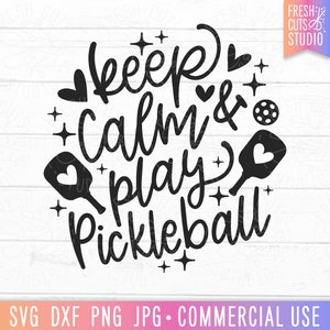 May include: Black and white graphic design with the text "Keep Calm & Play Pickleball" with paddle and ball illustrations.