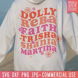 May include: White hoodie with a pink, orange, and red design that says "DOLLY REBA FAITH TRISHA SHANIA MARTINA" with flowers and stars.