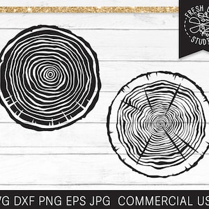 May include: Two black and white illustrations of tree rings. The tree rings are circular and have a concentric pattern. The illustrations are on a white wooden background.