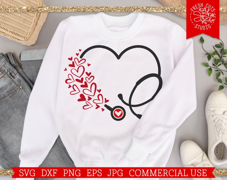 May include: White sweatshirt with a red heart and a black stethoscope design. The heart is surrounded by smaller red hearts.