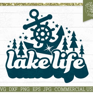 May include: A teal graphic with the words "lake life" in a stylized font, an anchor, stars, and pine trees. The image includes the text "FRESH CUTS STUDIO" and file type information.