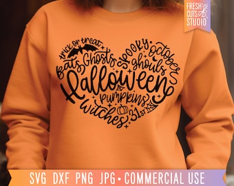 May include: An orange sweatshirt featuring a black heart-shaped design with Halloween-themed words like "bats," "ghosts," and "witches." The words are arranged to form the shape of a heart. The sweatshirt has a crew neck.