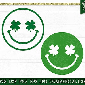 May include: Green smiley face with shamrock eyes. The shamrocks are white and the smiley face is outlined in green.