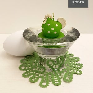 May include: Green and white polka dot chicken figurine on a glass candle holder with a white egg and a green crocheted doily. bobbin lace patterns by TINA KODER