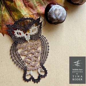 May include: A brown and beige bobbin lace owl with a detailed design. The owl is sitting on a brown surface with a leaf and chestnuts in the background. The text "bobbin lace patterns by TINA KODER" is visible in the lower right corner of the image.