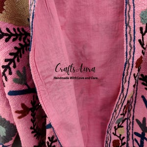 May include: Pink fabric with floral embroidery and the text "Crafts Aura Handmade With Love and Care."