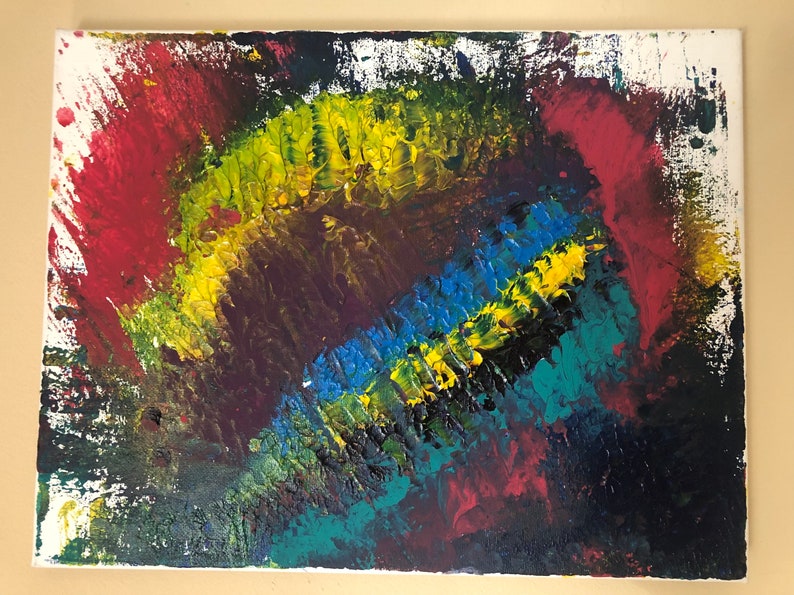 May include: Abstract acrylic painting on canvas. The artwork features a textured, colorful design with a rainbow of hues including red, yellow, blue, and green. The paint is applied in thick strokes, creating a dynamic and expressive piece.