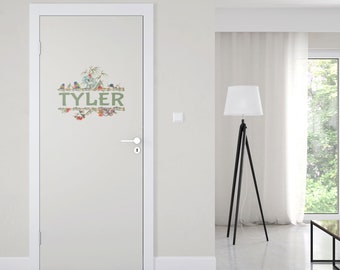 May include: A white door with a green and brown personalised name decal. The decal features the name "TYLER" surrounded by birds, flowers, and leaves.