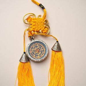 Tibetan Om Mantra Locket with Tassel – Divine Energy Amulet for Spiritual Awakening & Inner Peace