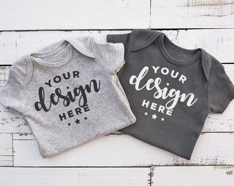 Download Free Gray Bodysuits Mock-up Closeup On Distressed Wood Background Infant Mock T-shirt Mock-up Commercial Template PSD Template