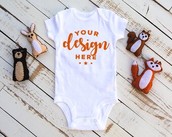 Download Free White Bodysuit Mock-up With Felt Woodland Animals On Distressed Wood Background Infant Mock T-shirt Mock-up Commercial Template PSD Template