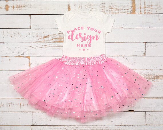 White Bodysuit Mockup With Infant Tutu Pink Sparkle On White Bodysuit Mockup With Infant Tutu Pink Sparkle On