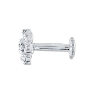 May include: A silver nose stud with a flower-shaped design featuring small clear stones.