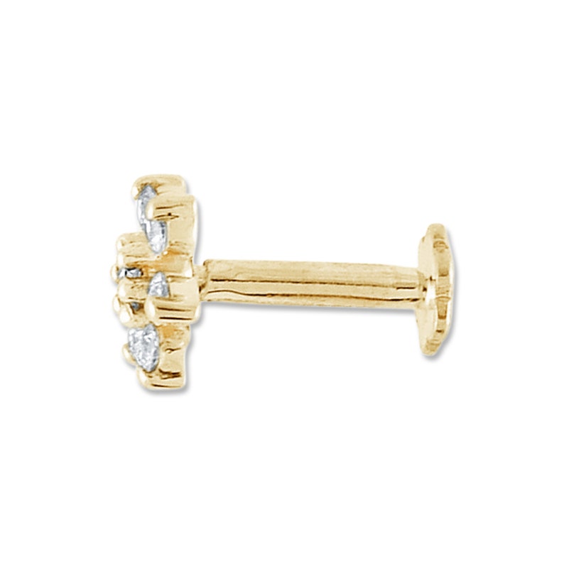 May include: A gold nose stud with a flower design featuring small clear stones.