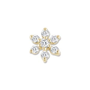 May include: A gold flower-shaped earring with clear round diamonds.