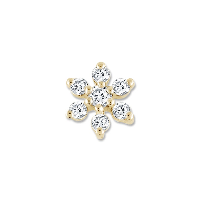 May include: A gold flower-shaped earring with clear round diamonds.