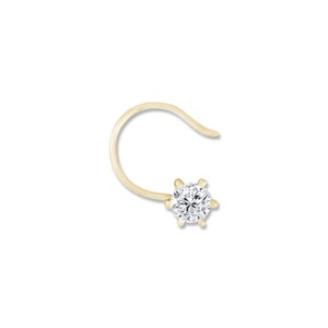 May include: A gold nose ring with a single round clear diamond.