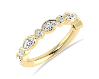 May include: A yellow gold ring featuring an alternating pattern of marquise-cut and round-cut clear gemstones set in a bezel style. The band is polished yellow gold, showcasing a continuous design of stones across the top half of the ring.