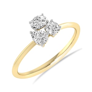 May include: A set of three ceramic mugs with a speckled, matte finish. The mugs are in shades of cream, light gray, and dark gray. Each mug has a simple, modern design and a rounded handle.