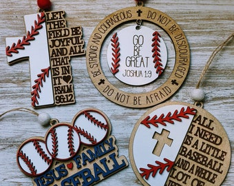 May include: Five wooden baseball-themed ornaments with religious messages. The ornaments are painted white with red stitching and a cross. The messages include "Let the field be joyful", "Go be great", "Jesus Family Baseball", and "All I need is a little baseball and a whole lot of Jesus".