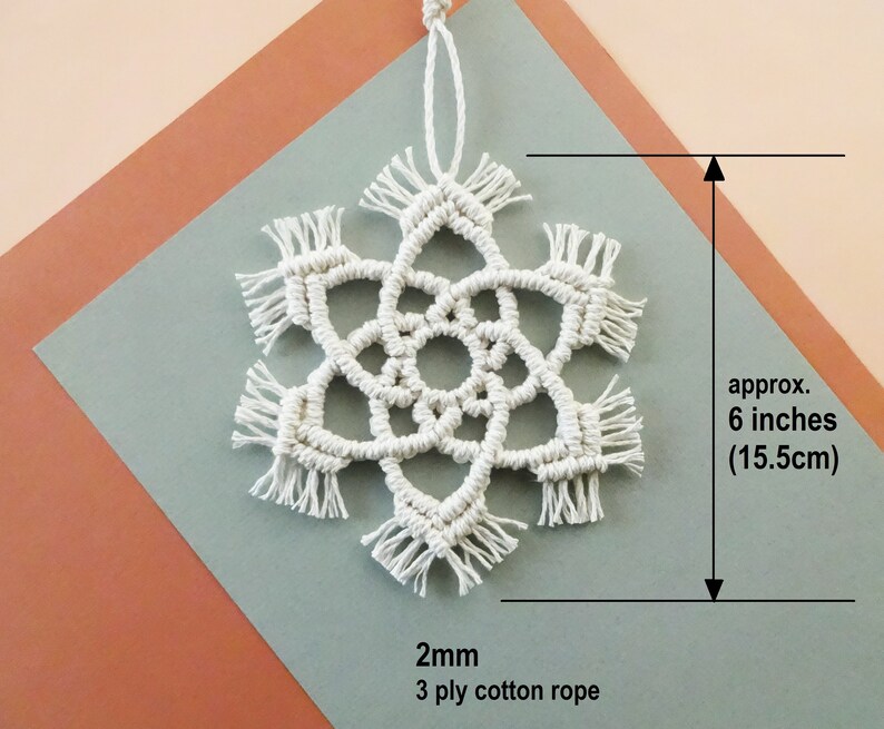 May include: White macrame snowflake ornament made with 2mm 3 ply cotton rope. The snowflake is approximately 6 inches (15.5 cm) in diameter.