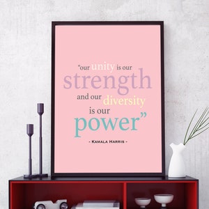 May include: A pink framed print with a quote by Kamala Harris that reads "our unity is our strength and our diversity is our power".