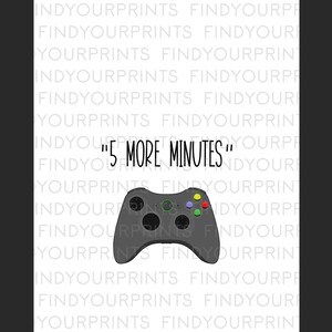 May include: A black and green video game controller with the text "5 More Minutes" printed on a white background.