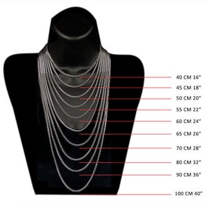 May include: A silver chain necklace on a black mannequin, showing different lengths from 16 inches to 40 inches. The lengths are marked in centimeters and inches.