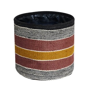 May include: Cylindrical woven basket with a black rim and a black plastic liner. The basket features horizontal stripes in black, white, burgundy, and gold. This decorative basket is suitable for storage or as a planter.