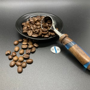 Hand turned Coffee Scoop, featuring different woods and colors resin featuring shimmering light hues.