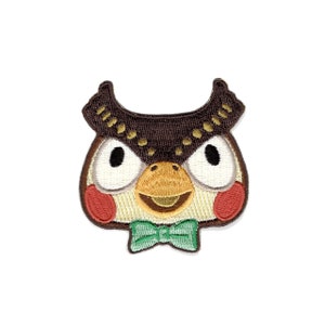 May include: Embroidered patch of a brown owl with large eyes, a yellow beak, and a green bow tie. The owl has red cheeks and a white face.