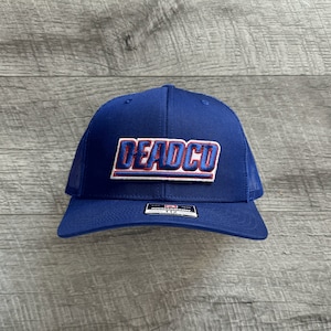 May include: A blue trucker hat with a red and white embroidered patch that says "DEADCO".